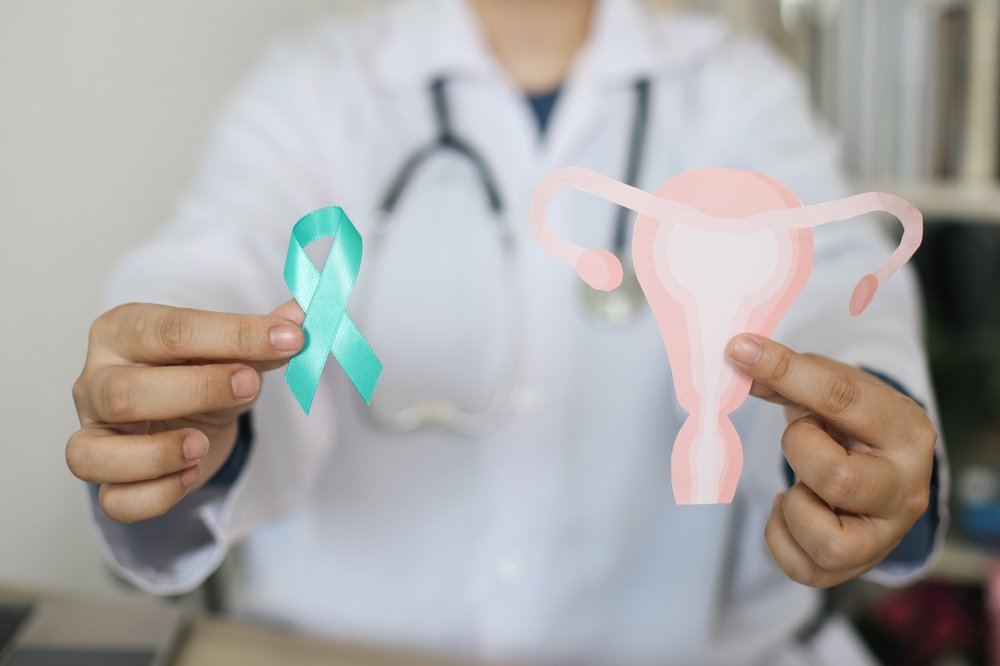 Doctor,Hands,Showing,Teal,Awareness,Ribbon,With,Cervix,Shape.,Ovarian